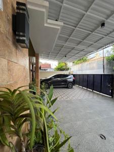 a car parked inside of a garage with a car parked at Tentrem Madani in Yogyakarta