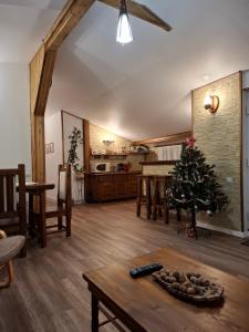 a living room with a christmas tree on a table at Casa Zaharia Azuga in Azuga