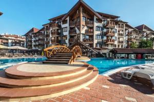a resort with a swimming pool and a building at 400m from Ski lift Belvedere Apartment - SPA - Free parking in Bansko