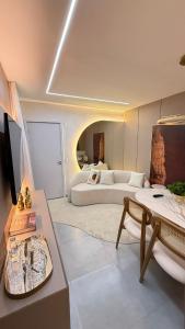 a large room with a bed and a table and a couch at Apartamento em Juazeiro do Norte in Juazeiro do Norte +6 photos