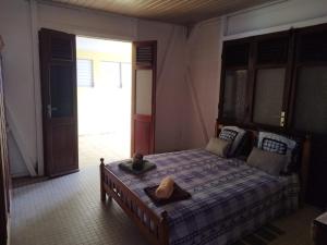 a bedroom with a bed with a hat on it at la bella vita in Port-Louis