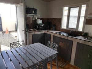 a kitchen with a wooden table and a table and chairs at la bella vita in Port-Louis +7 photos