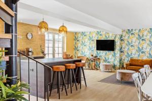 a kitchen and living room with a bar with stools at 193-Vestervig-Vesterhavsvej-36 in Vestervig