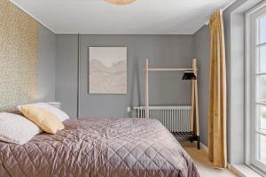 a bedroom with a large bed and a window at 193-Vestervig-Vesterhavsvej-36 in Vestervig