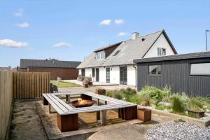 a backyard with a fire pit in front of a house at 193-Vestervig-Vesterhavsvej-36 in Vestervig