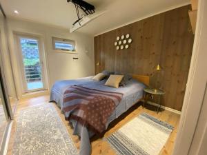 a bedroom with a bed and a window at Lovely view & walking distance to the beach SE09150 in Svanesund