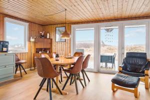 a kitchen and dining room with a table and chairs at 525-Vestervig-Spovevej-5 in Vestervig