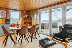 a living room with a table and chairs and a kitchen at 525-Vestervig-Spovevej-5 in Vestervig +18 photos