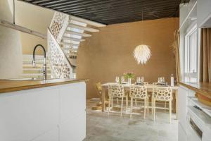 a kitchen and dining room with a table and chairs at 302-Snedsted-Klitfogedvej-7 in Snedsted +32 photos