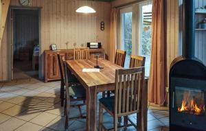 a dining room with a wooden table and a fireplace at Amazing Home In Rechlin With Wifi in Rechlin