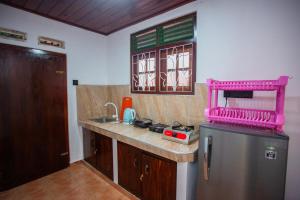 een keuken met een spoelbak en een koelkast bij jenul villa in Ahangama