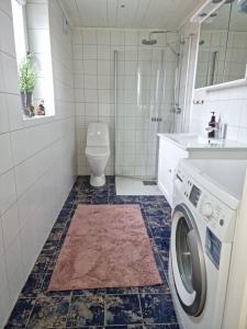 a bathroom with a washing machine and a toilet at Modern Cottage with Sea View in Svanesund SE09151 in Svanesund +18 photos