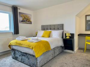 a bedroom with a bed with two towels on it at City & Station Stays at Gulland House by Pureserviced in Plymouth