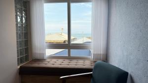 a window in a room with a view of a pool at Pousada Gamboa estações in Garopaba