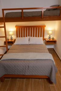 a bedroom with a bed with two bunk beds at Suspiros de arica in Arica