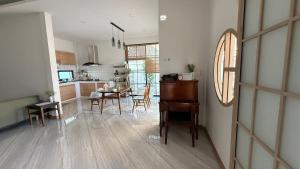 a kitchen and dining room with a table and chairs at Home No 5 in Ratchaburi
