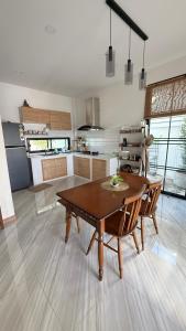 a kitchen with a table and chairs in a room at No 5 Home in Ratchaburi