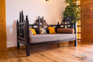 a bench with pillows on it in a room at Andu Kuboiye Homes in Kimana