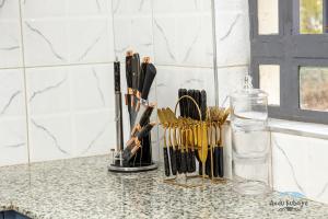 a counter with a bunch of kitchen utensils on it at Andu Kuboiye Homes in Kimana