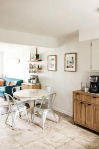 a kitchen with a table and chairs in a room at Sanderling - Pet Friendly - Walk to Beach - Pool! in Holden Beach
