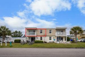 a house with bikes parked in front of it at Sanderling - Pet Friendly - Walk to Beach - Pool! in Holden Beach