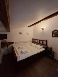 a bedroom with a bed with two towels on it at Casa Zaharia Azuga in Azuga