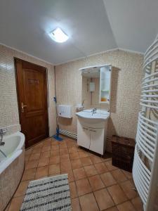 a bathroom with a tub and a sink and a bath tub at Casa Zaharia Azuga in Azuga