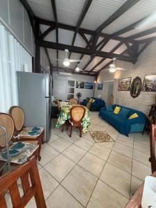 a living room with a refrigerator and a couch at Maison charmante à Fort-de-France avec équipements modernes in Fort-de-France