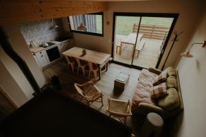 a living room with a couch and a table at Aux Choses Simples in Pradiers