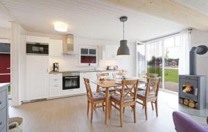 a kitchen and dining room with a table and chairs at Lykkebo in Wandlitz