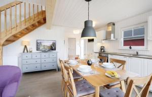 a kitchen and dining room with a wooden table and chairs at Lykkebo in Wandlitz