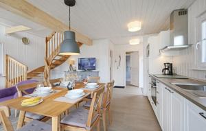 a kitchen and dining room with a table and chairs at Lykkebo in Wandlitz +11 photos