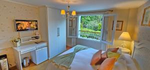 Un televizor și/sau centru de divertisment la Pousada Atalaia Premium