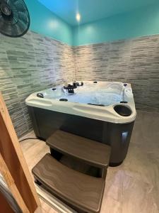 a bathroom with a large bath tub in a room at Maison charmante à Fort-de-France avec équipements modernes in Fort-de-France +97 photos