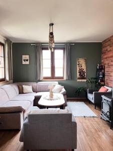 a living room with a couch and a table at Przystanek Gałkowo in Gałkowo