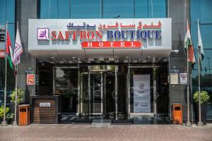 a building with a sign for a hotel at Saffron Boutique Hotel in Dubai