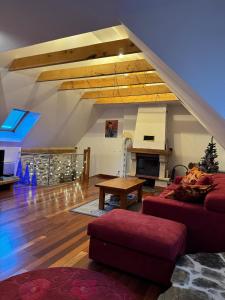a living room with a couch and a table at Grange des Taouré in Vignec