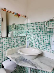 a bathroom with a sink and a mirror at Mandacaru Pousada in Porto Seguro +42 photos