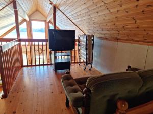 a living room with a tv and a couch at Holiday home- 50m to sandy beach at Kavlanda Brygga SE09147 in Tviklippan