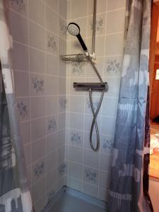 a shower with a shower head in a bathroom at Holiday home- 50m to sandy beach at Kavlanda Brygga SE09147 in Tviklippan +25 photos