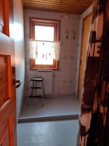 a small room with a window and a stool at Holiday home- 50m to sandy beach at Kavlanda Brygga SE09147 in Tviklippan