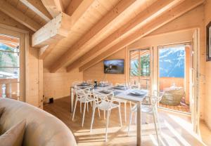 a dining room with a table and chairs at Chalet Aberot in Wengen