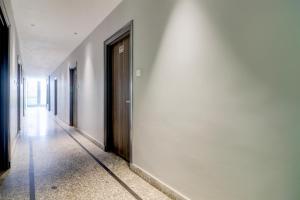 a hallway of a building with a door on a wall at Super Hotel O Gold Inn in Rohtak