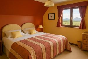 a bedroom with a large bed and a window at Ocean View Lodge in Kilchiaran