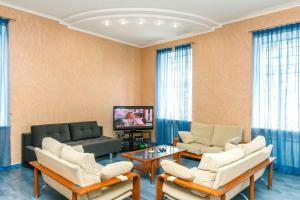 a living room with a couch and chairs and a tv at Three bedroom, 8 Lyuteranska str, Centre of Kiev in Kyiv