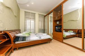 a bedroom with a bed and a mirror at Three bedroom, 8 Lyuteranska str, Centre of Kiev in Kyiv