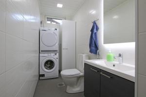 a bathroom with a washing machine and a washer and dryer at Amiraali in Jämsä +15 photos