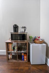 a kitchen with a refrigerator and a shelf with food at Historic 4BR Home near Lynchburg Colleges in Lynchburg