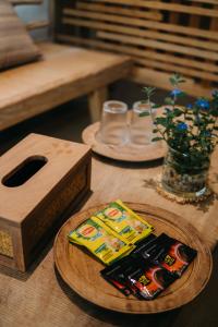 a wooden table with a box of chips on a table at Nong Lam Ecolodge in Linh Xuân Thôn