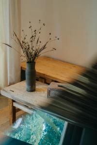 a table with a potted plant on it next to a window at Nong Lam Ecolodge in Linh Xuân Thôn